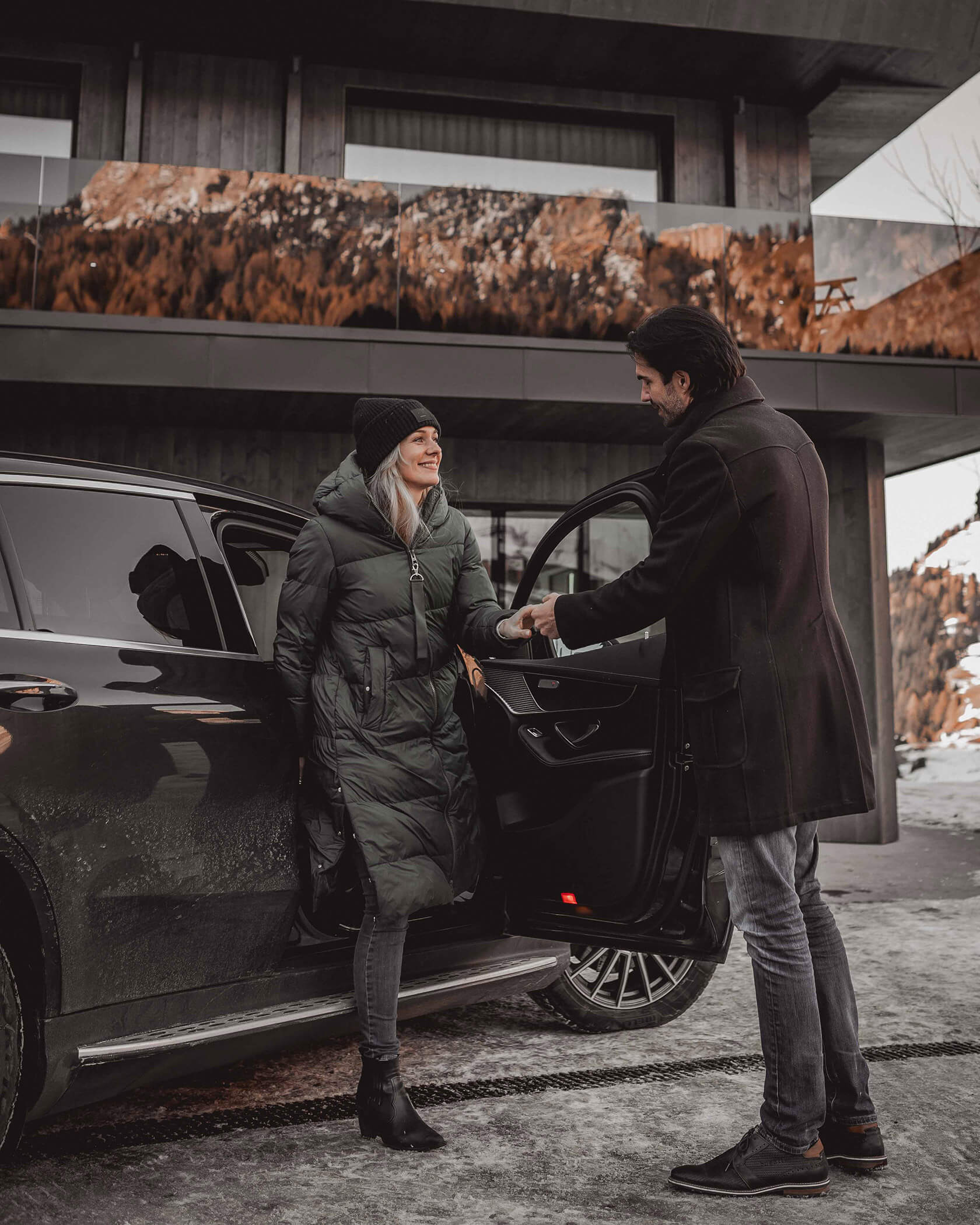 Mann hilft Frau aus dem Auto - Hotel Continental