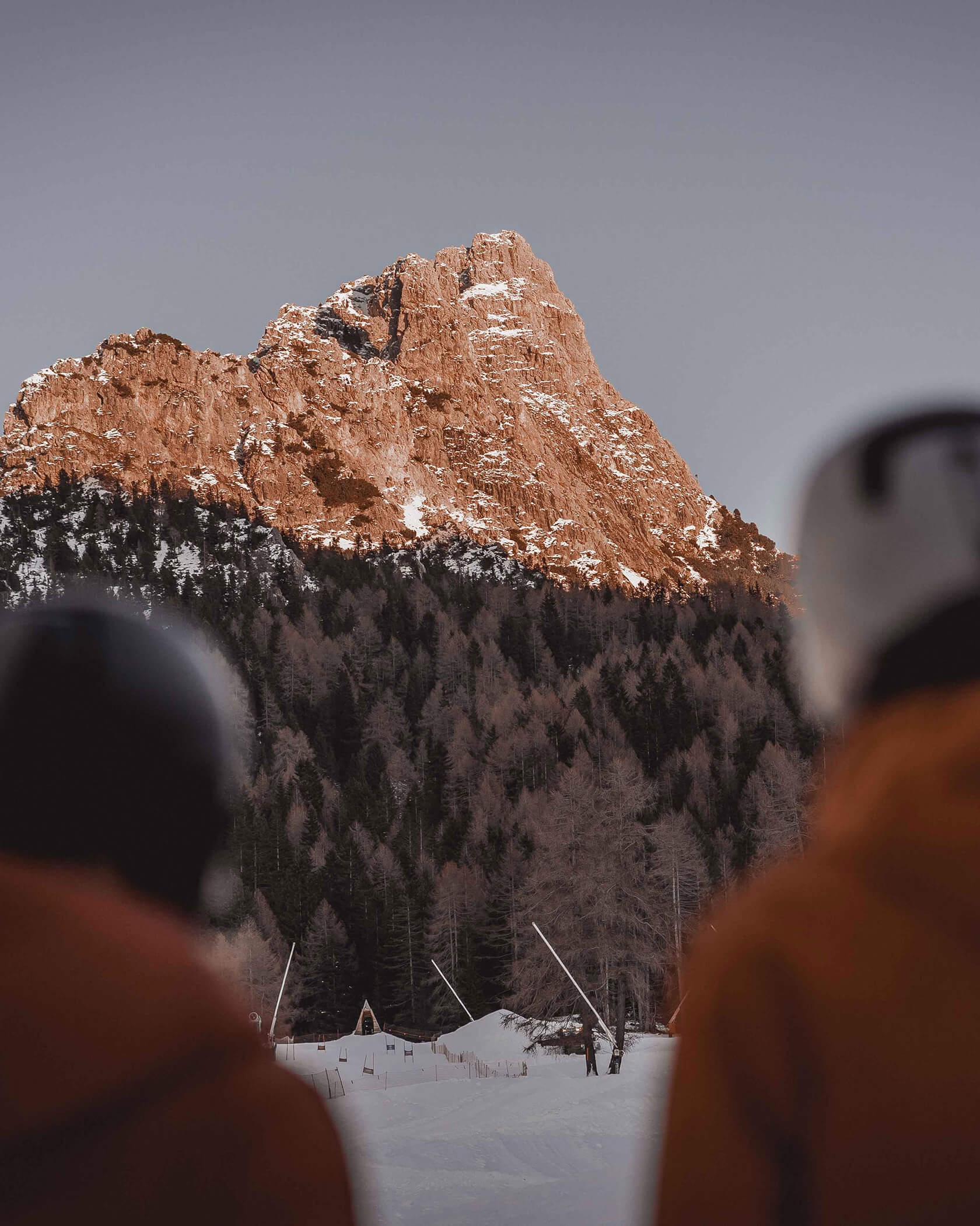 Two skiers looking at the sunlit mountain - Hotel Continental