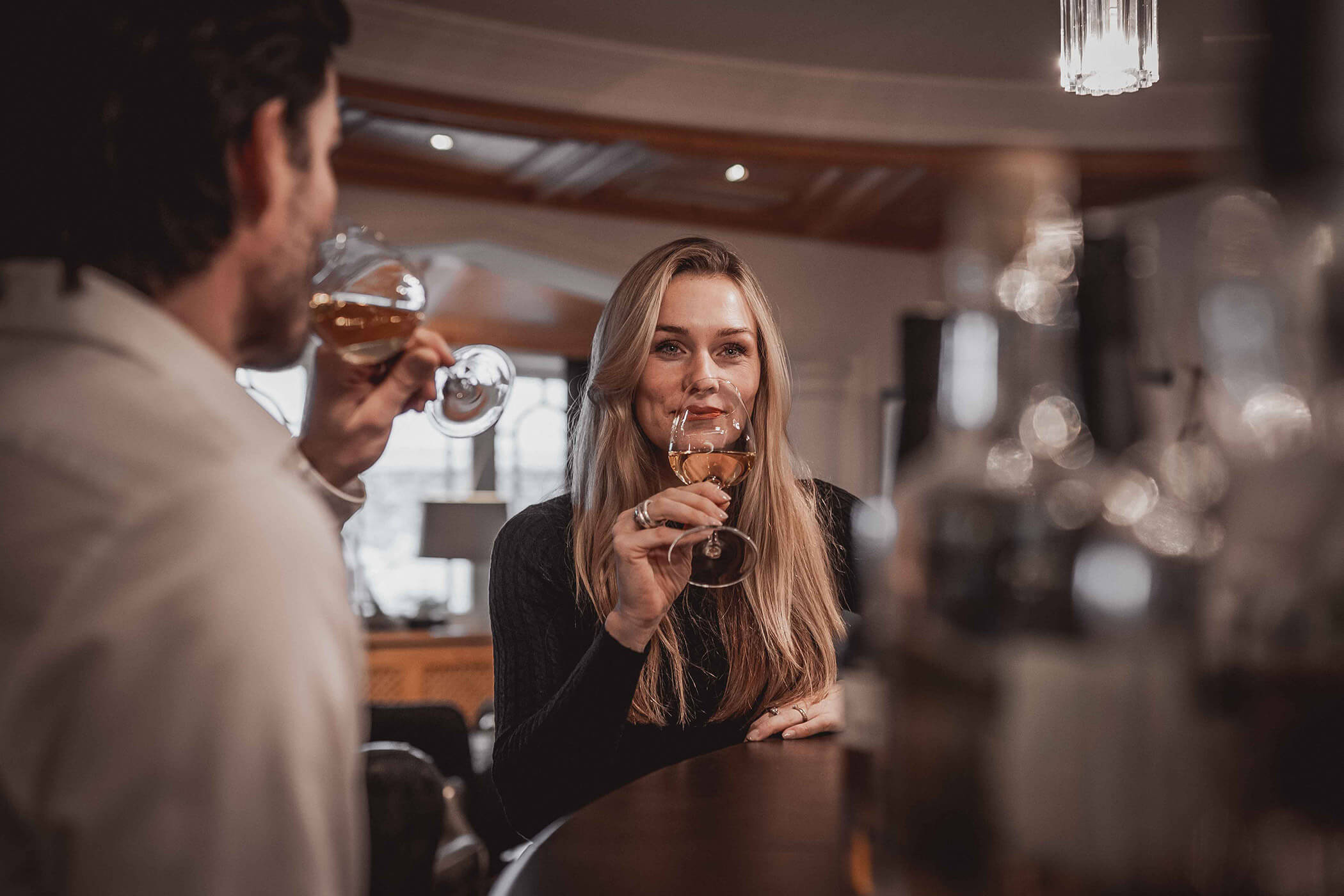 A couple tasting white wine at the hotel bar - Hotel Continental