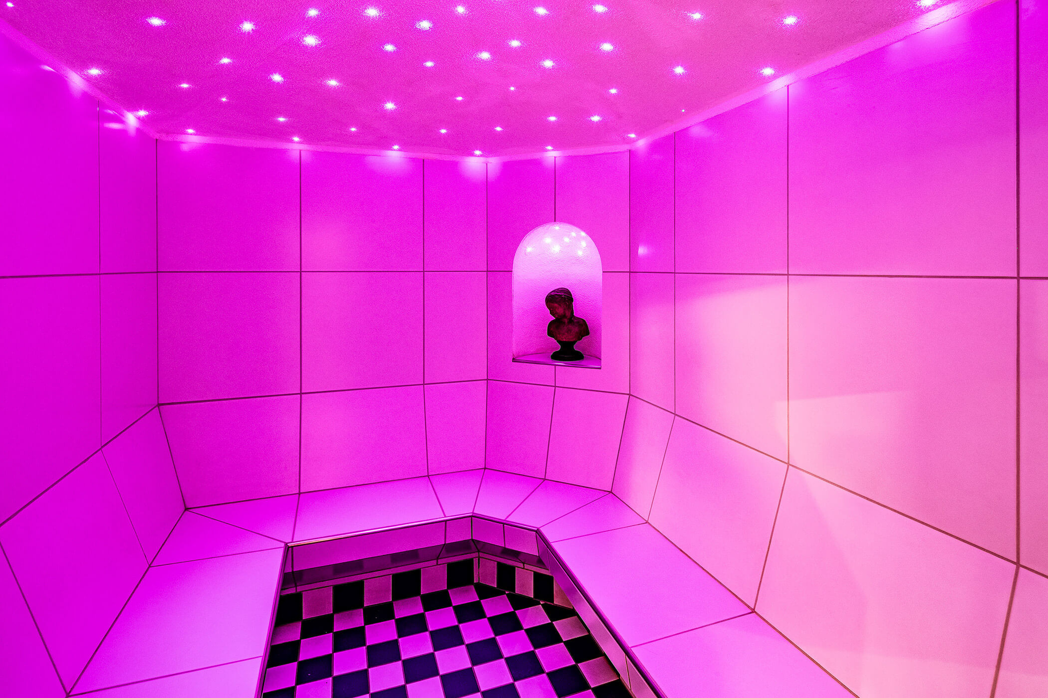 Steam bath with purple light and statue in the background - Hotel Continental