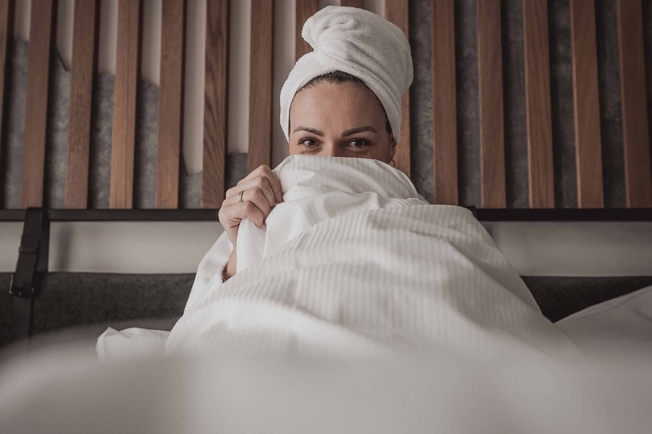 Woman with towel on her head, hidden behind the quilt - Hotel Continental