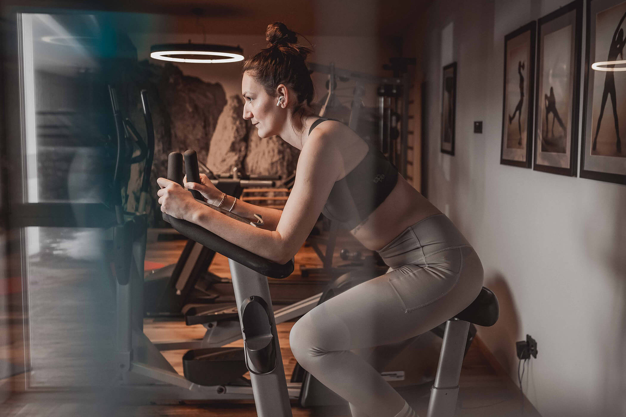 Woman training on a stepper in the fitness room - Hotel Continental