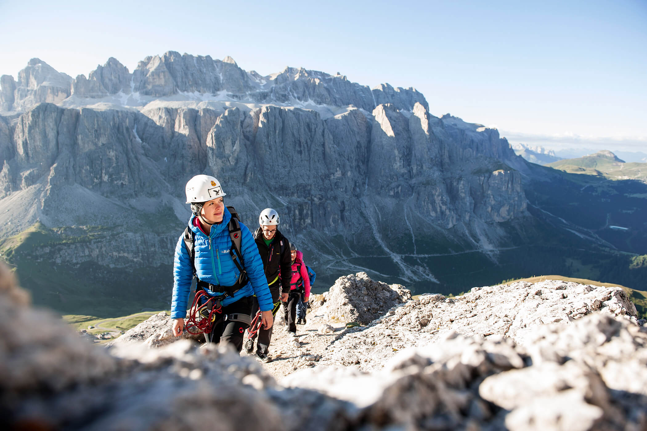 Three hikers with climbing helmets in front of a breathtaking mountain panorama - Hotel Continental