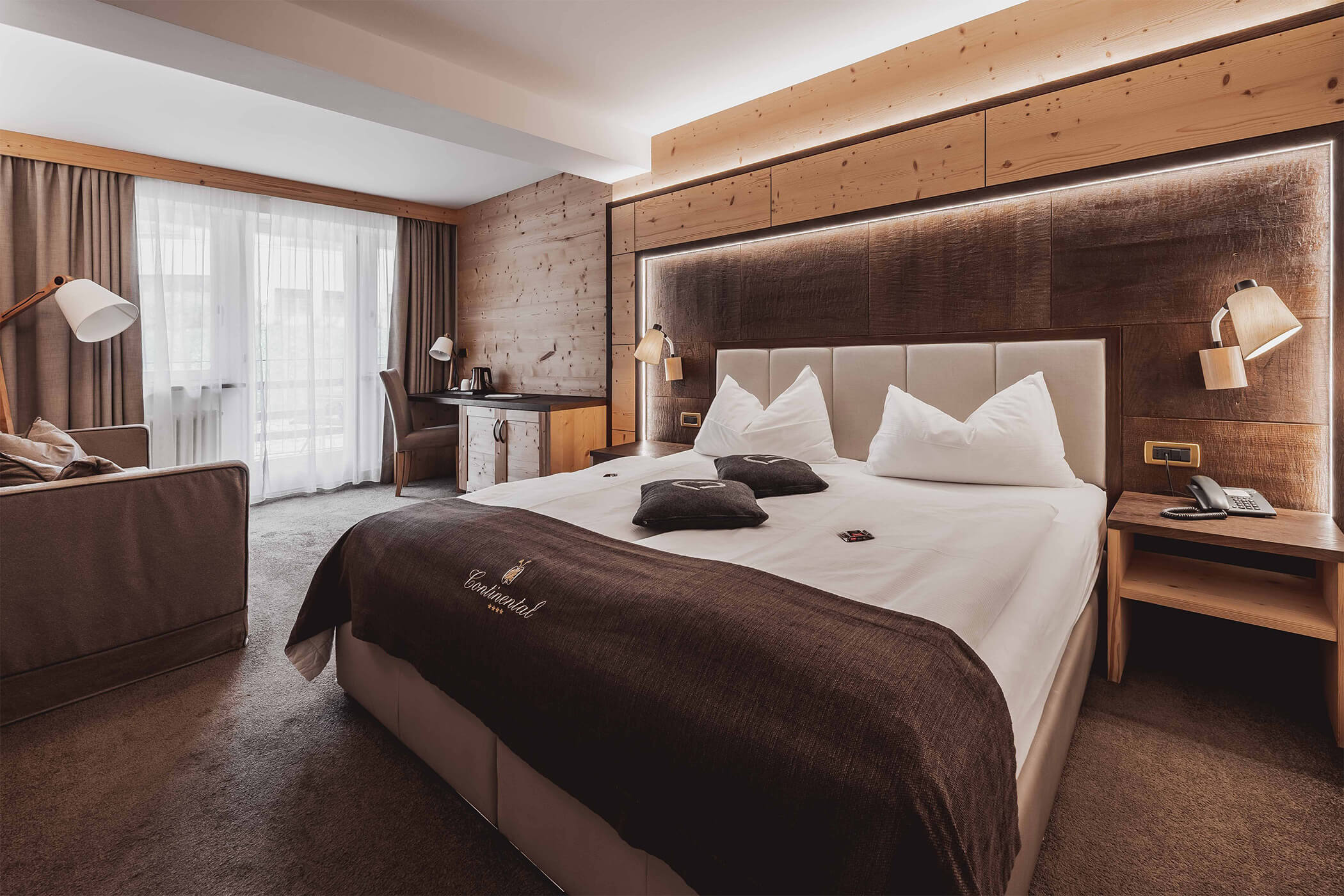 Double bed with illuminated back wall in the Classic double room 