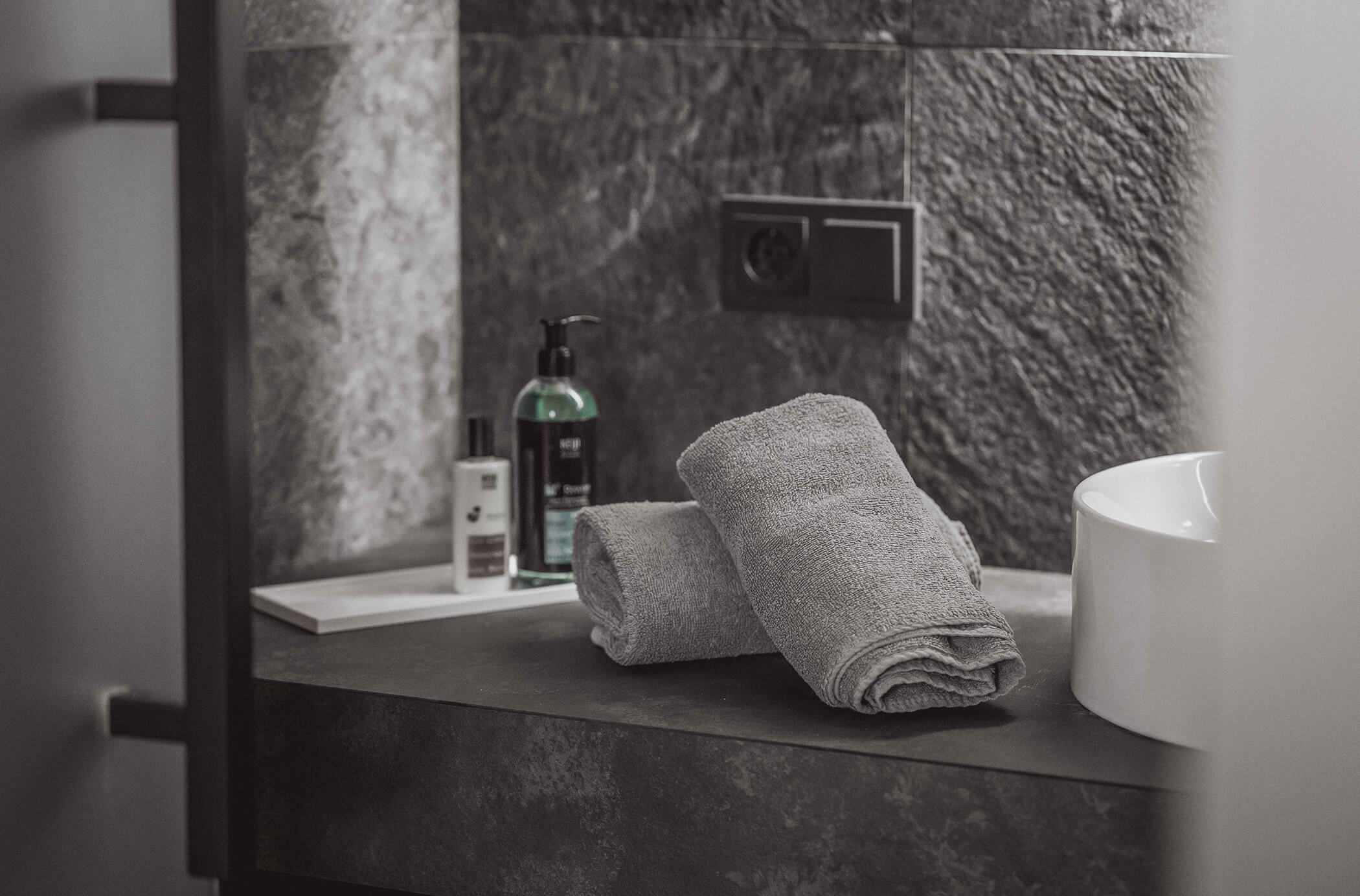 Two gray towels in the bathroom with soap in the background - Hotel Continental