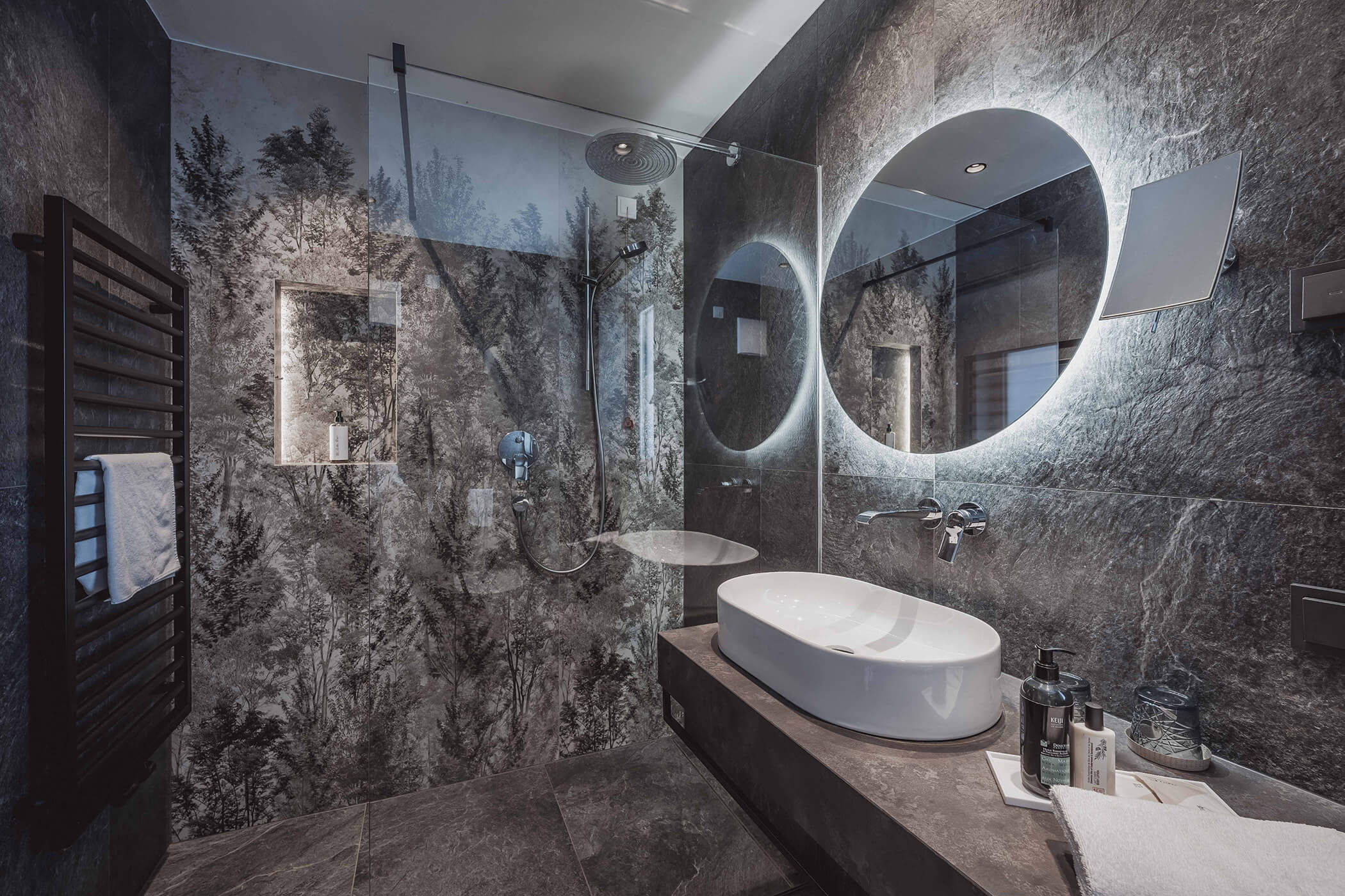 Modern bathroom with rain shower, illuminated mirror and round sink - Hotel Continental