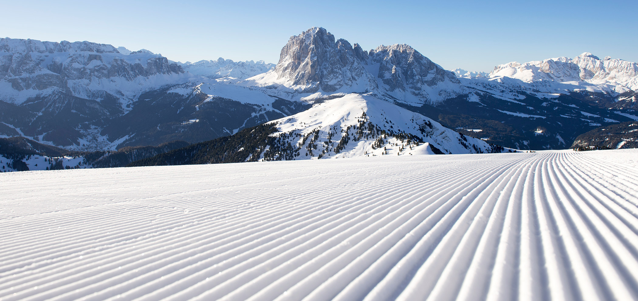 Newly groomed ski slope with mountains in the background - Hotel Continental